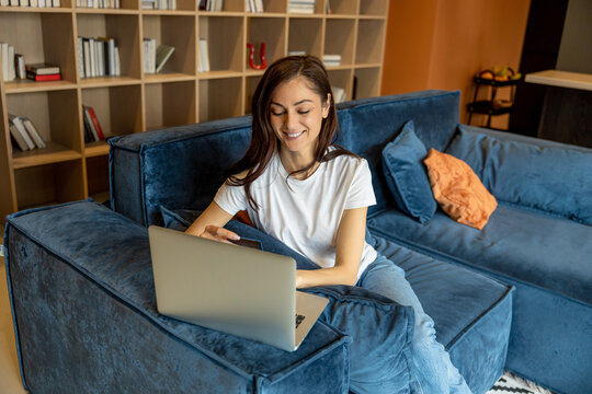 Young woman having a video call and looking joyful