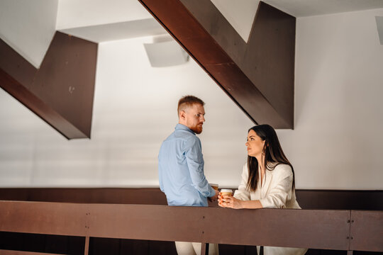 Coworkers discussing business during coffee break