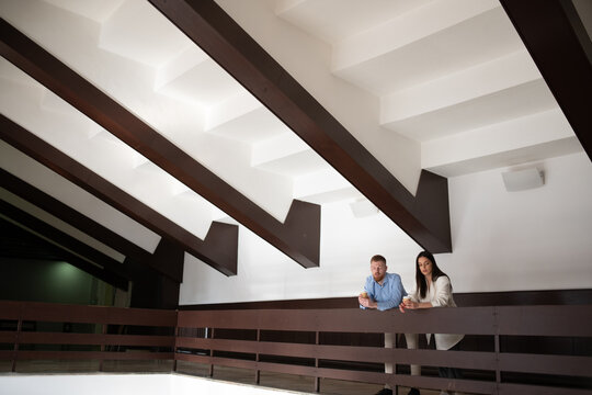 Business colleagues having coffee break on balcony