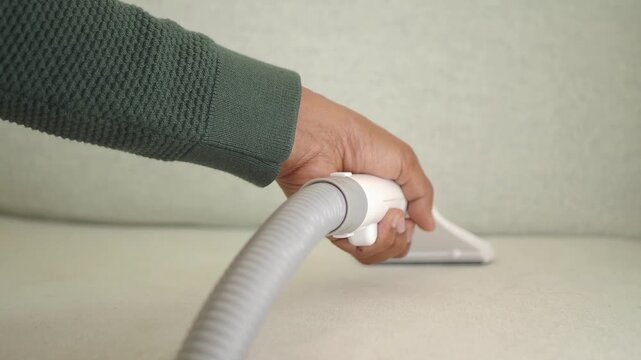 Cleaning a couch with a vacuum attachment