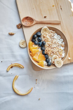 Healthy breakfast with oatmeal cereal, banana, blueberry, orange
