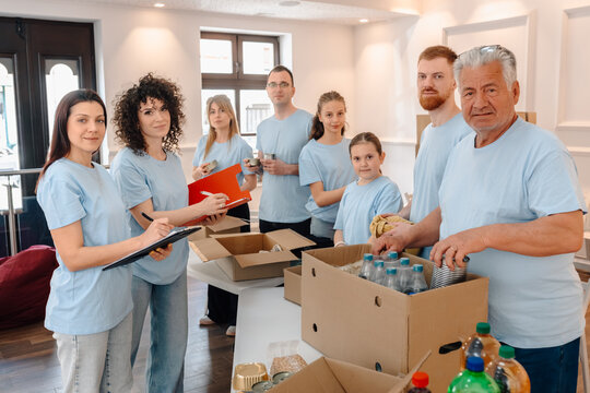 Volunteers packing food donations for community charity service