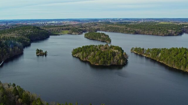 Aerial view of forested islands and calm lake in Stora Delsjon nature reserve, Sweden