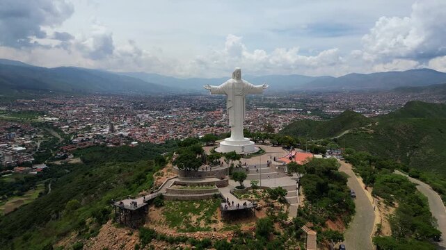 Cinematic drone flyover revealing the iconic Jesus Christ monument overlooking Cochabamba, Bolivia.