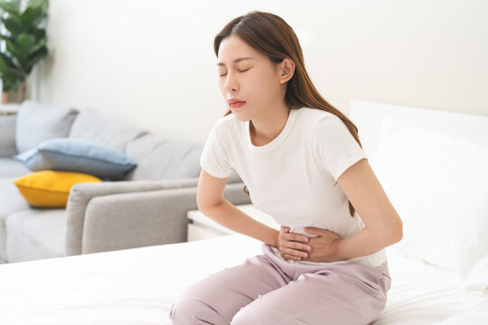 Flatulence ulcer, asian young woman, girl hands in belly, stomach pain from food poisoning, abdominal pain and digestive problem, gastritis or diarrhoea. Abdomen inflammation, menstrual period people.