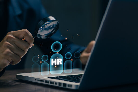 Human resources recruitment concept with magnifying glass analyzing candidates, highlighting talent acquisition, employee selection, workforce management and hiring strategy.