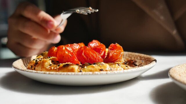 Eating whipped feta with roasted cherry tomatoes