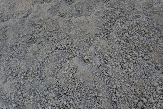 Close-up of volcanic sand surface used as construction material in Java, Indonesia. Natural aggregate texture suitable as a background for building, engineering, and architectural concepts.