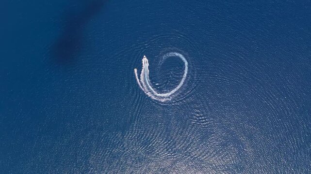 Aerial circular boat wake swirling