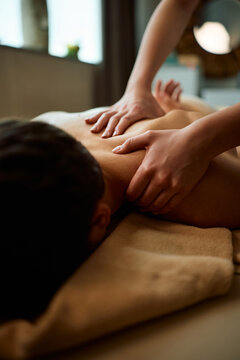Close up of man receiving back massage at spa.
