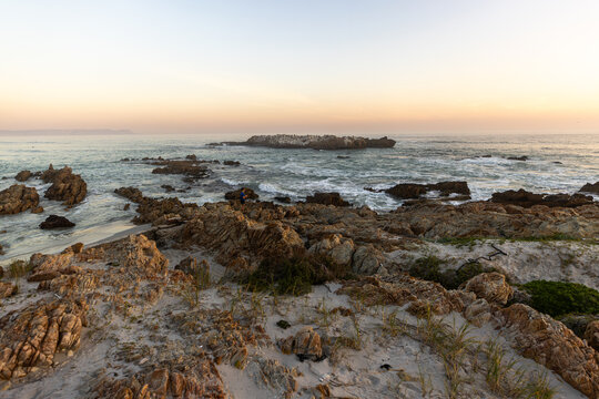 beautiful rugged rocky coastline of Kammabaai Beach, Hermanus, South Africa at sunset and dusk