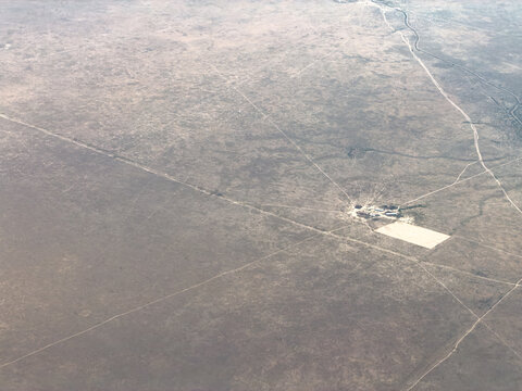 Aerial view of an isolated structure in a barren landscape