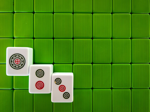White Mahjong Tiles on Green Textured Backing with Copy Space