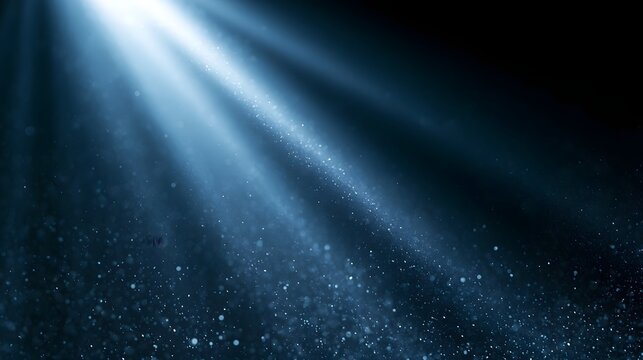 A radiant blue beam of light illuminates floating particles against a dark background  creating an ethereal and abstract scene