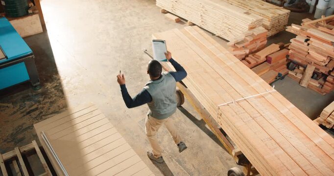 Dancing, man and woodworker with tablet in workshop with good news on artisan project order. Digital technology, fun and carpenter with groove for finished furniture manufacturing from above.