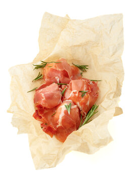 Prosciutto slices with rosemary wrapped in paper.