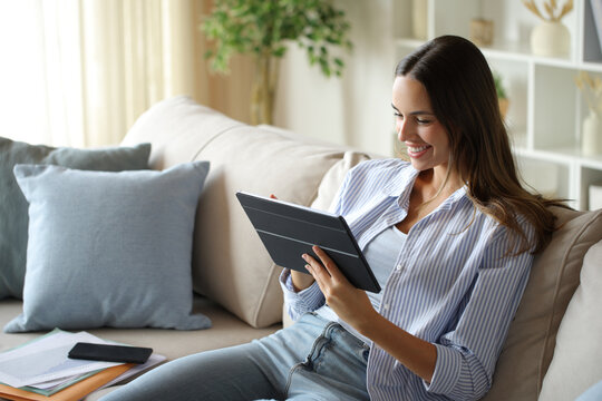 Happy teleworker working online using tablet at home
