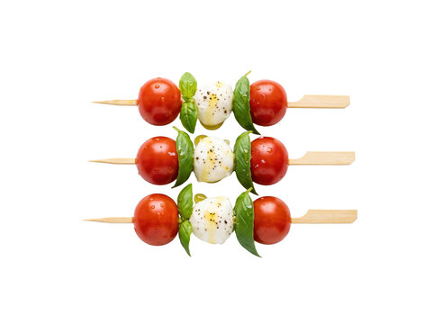 Caprese skewers with tomato and mozzarella. Fresh basil appetizers on wooden sticks.