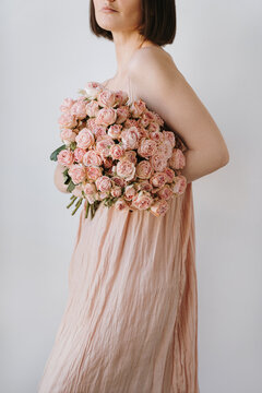 Woman Holding Bouquet of Pink Flowers