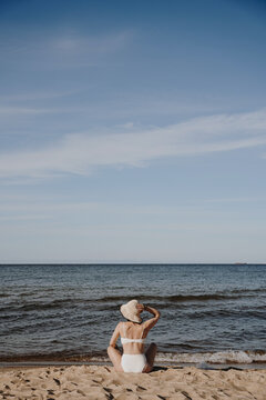 Woman in Bikini Sitting on Beach