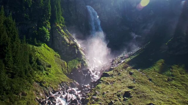 Staubenfall Waterfall in Isenthal Valley, Uri, Switzerland. Scenic view of Staeubenfall Waterfall cascading down a steep rocky cliff in the Isenthal Valley, Canton of Uri, Switzerland.