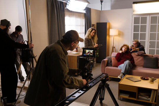 Professional cameraman films an actress on set with the crew