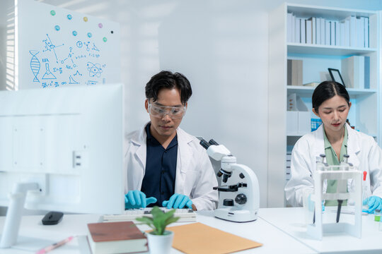 Scientists perform laboratory research using microscopes, test tubes, and modern scientific equipment to analyze samples, representing biotechnology, healthcare, diagnostics, and medical innovation.