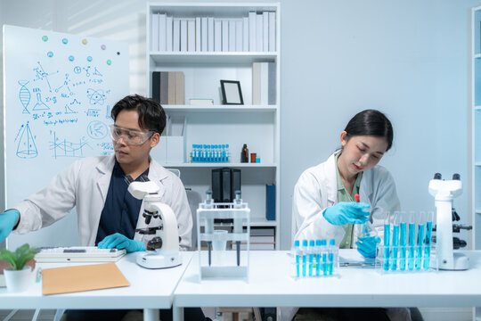 Scientists perform laboratory research using microscopes, test tubes, and modern scientific equipment to analyze samples, representing biotechnology, healthcare, diagnostics, and medical innovation.