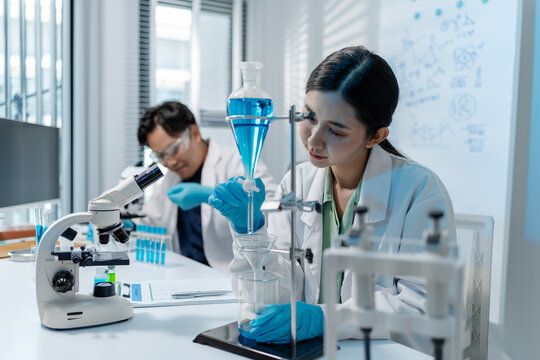 Scientists analyze liquid samples using test tubes, microscopes, and laboratory equipment, representing biotechnology, medical diagnostics, research, and healthcare innovation.