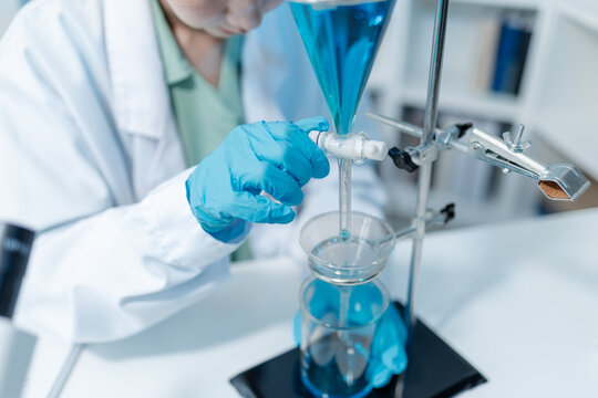 Scientists analyze liquid samples using test tubes, microscopes, and laboratory equipment, representing biotechnology, medical diagnostics, research, and healthcare innovation.