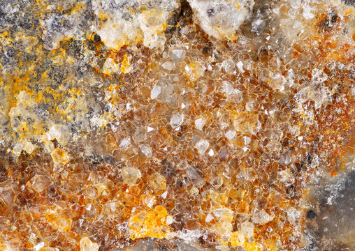 Close view of mineral surface showing various crystal formations and colors