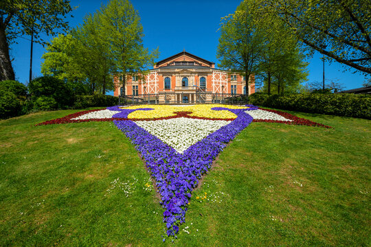 Colorful flowers growing in front of Bayreuth Festspielhaus against clear sky during sunny day, Bayreuth, Germany