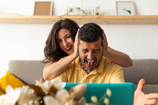 Happy couple enjoying fun moments at home laughing