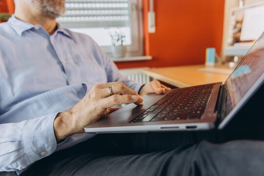Businessman works on laptop in modern office