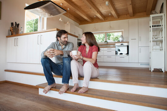 Mature couple sitting on floor, talking about future