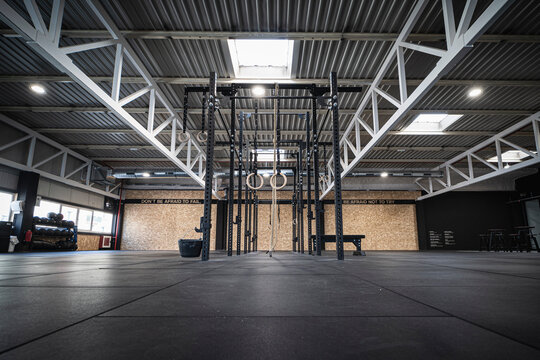 Gymnastic rings and ropes hanging in empty gym