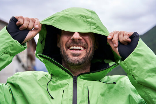 Happy man wearing hooded green jacket