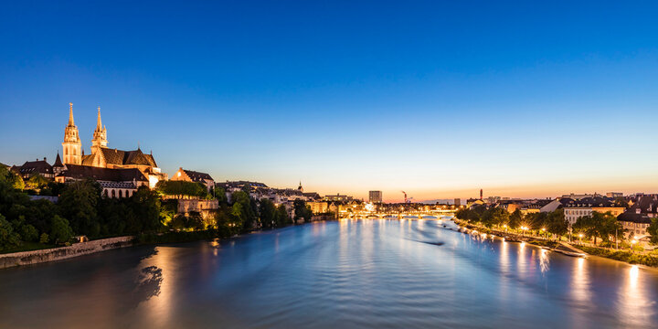 Switzerland, Basel-Stadt, Basel, Long exposure of river Rhine at dusk with Basel Minster cathedral in background