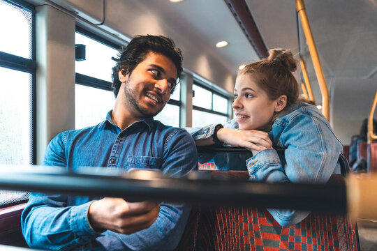 Friends travelling together by bus, London, UK