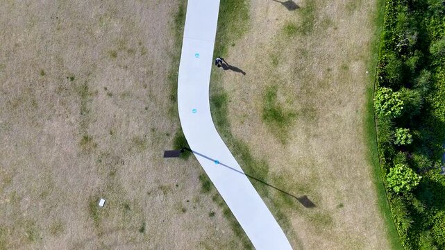 Aerial Top Down View of Man Walking on Park Path