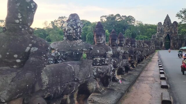 Angkor Wat Causeway with Stone Statues and Moat at Sunset Siem Reap Cambodia Pan