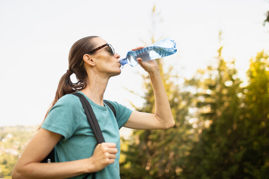 Woman Drinking Water During Hike Hydration Fitness and Healthy Lifestyle	