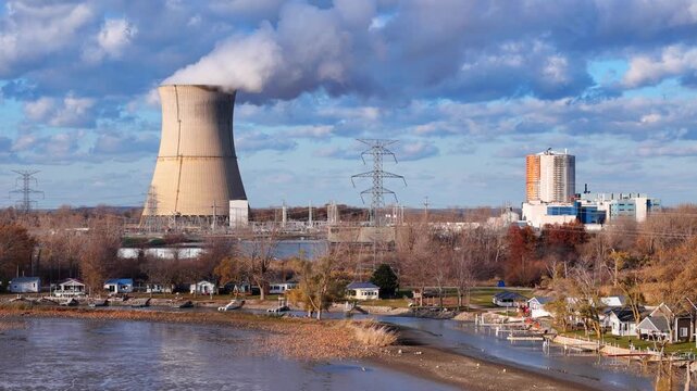 Industrial landscape with the Davis-Besse Nuclear Power Station releasing steam into the sky