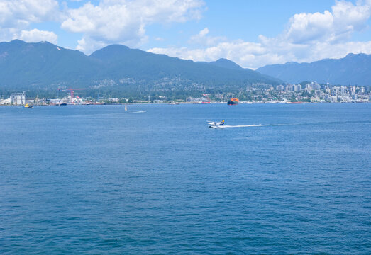 Float Planes Moored at Vancouver Harbour Flight Centre with Stanley Park and North Shore Mountains in Vancouver, Canada