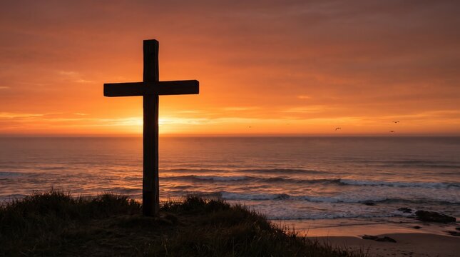Silhouette of wooden cross on cliff overlooking ocean at sunset, christian faith symbol against dramatic orange sky and sea waves, religious spirituality landscape scene