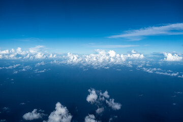 Fototapeta premium Aerial view of fluffy clouds over the Pacific Ocean in Polynesia