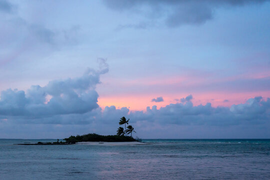 Sunset over a tropical motu on Tikehau Atoll, French Polynesia