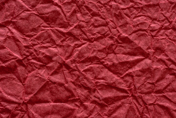 Fototapeta premium Red crumpled paper texture close up, visual artist crafting bold campaign visuals, intense crimson folds, dynamic wrinkles and textured shadows perfect for sale banners, posters