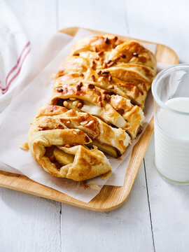 Apple pastry with pine nuts and glass of milk, dessert for cafes and bakeries