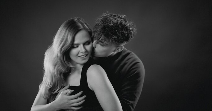 Loving couple embracing and kissing, expressing romance and closeness
